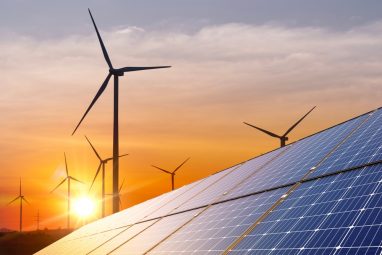 Wind,Turbine,With,Solar,Panels,And,Sunset.,Concept,Clean,Energy.