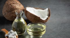 a jug of coconut oil whit coconut put on dark background